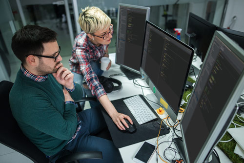 Two office workers solving a problem